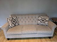 Full front view of sofa with two accent pillows