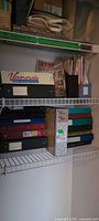 Closet shelf with Vanna’s binder and additional pattern binders