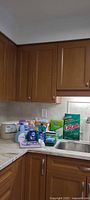 Overview of assorted cleaning supplies on kitchen counter.