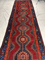 Full view of long red geometric runner rug