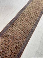 Angled view of rug highlighting texture and border design