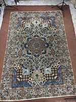 Full view of the Kashan rug showing entire pattern and borders