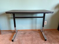 Front view of desk showing full structure and adjustable legs