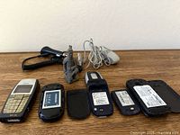 Rear view of phones with back covers removed and accessories in background