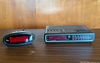 Front view of both digital alarm clocks showing displays and branding