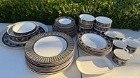 Full set showing stacks of plates, bowls, mugs and trays