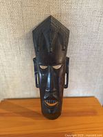 front view of carved African mask showing details