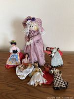 All six dolls grouped on wooden surface