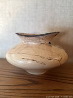 Front view of squat horsehair raku vase showing veining pattern and lip shape