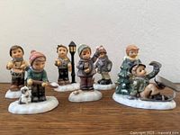 Front view of six Hummel winter figurines