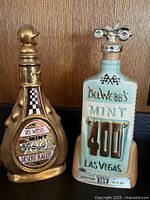 Front view of both Jim Beam Mint 400 decanters showing designs