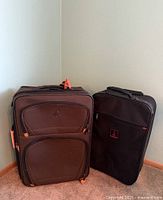 Both suitcases standing to show size, color, and front pocket layout