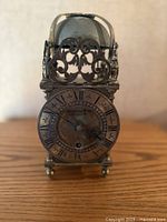 Front view showing dial, fret, bell and columns