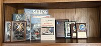 Full shelf view showing books and award plaques