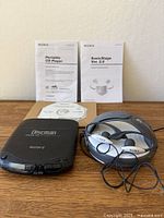 Discman, Walkman with earbuds, manuals and CD-ROM overview