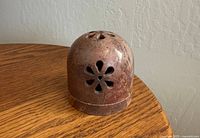 Full view of stone tea light holder showing floral cutout