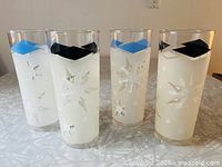 All four frosted Atomic Snowflake hi-ball glasses showing blue and black diamond rims