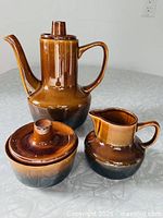 Coffee/tea pot, sugar bowl with lid, and creamer grouped