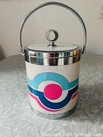 Front view of ice bucket showing graphics and handle