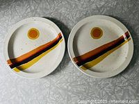 Both Midwinter Stonehenge Day plates front view