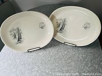 Two oval Yacht Race platters on table