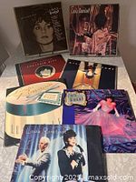 Group shot of all seven Linda Ronstadt LPs spread on surface