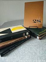 Group shot of six mid-century advertising and design annuals on a table