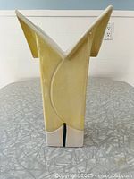 Full side view of angular vase showing color and form