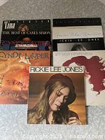 Group shot displaying several album covers for visual confirmation