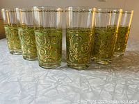 Front view of all six Culver Toledo tumblers with gold and green enamel decoration