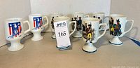 Group of eight pedestal mugs showing both eagle and soldier designs