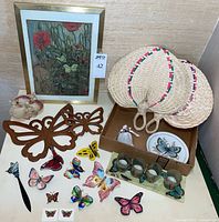 Entire lot overview showing framed print, fans, wooden accents, seashell, plate, tealight holders, ornaments