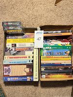 Overall box of VHS tapes, DVDs, and sealed Fuji blank tapes