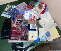 Overview of lot showing grouped handkerchiefs and bow ties