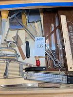 Drawer view showing majority of utensils and knives