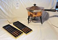 Entire fondue set with forks and instructions displayed