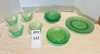 All 15 green depression glass pieces grouped
