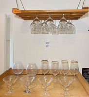 Rack suspended with various glasses hanging and displayed