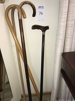 Four canes leaning against wall