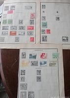 Three album pages showing stamps for Anjouan, Azerbaijan and others