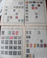Four album pages laid out showing assortment of Austria stamps mounted