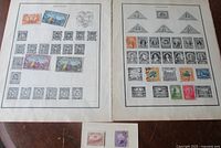 Two Scott album pages filled with Ecuador stamps and one loose album card