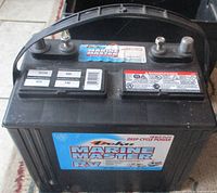 Front view showing battery case, handle, terminals, spec label