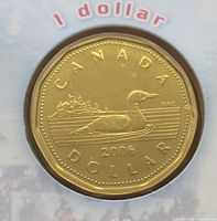 Reverse of 2006 Canadian dollar coin showing loon, island, CANADA, DOLLAR inscription