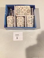 Boxed set showing dispenser, two tumblers and soap dish