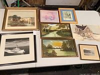 All eight artworks laid out on table