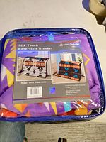 Packaged Nu Trendz reversible blanket in zippered case