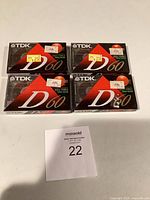 Front view of four sealed TDK D60 cassette tapes