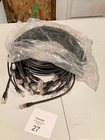 Bundle of black Cat5e cables coiled together showing multiple RJ45 ends