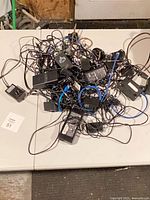 Tangle of chargers and cables spread on table